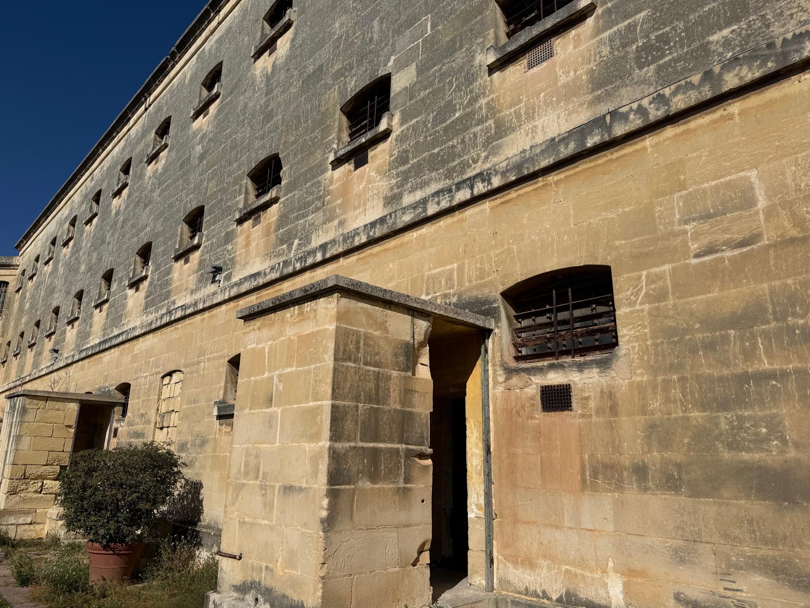 Kordin wall at dusk, barred windows
